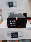 Wanptek TCP605D Programmable DC Power Supply 0-60V 0-5A Digital Bench Power Supply - a digital display reading 61.00V, 5.200A, and OFF, with boxes in the background.